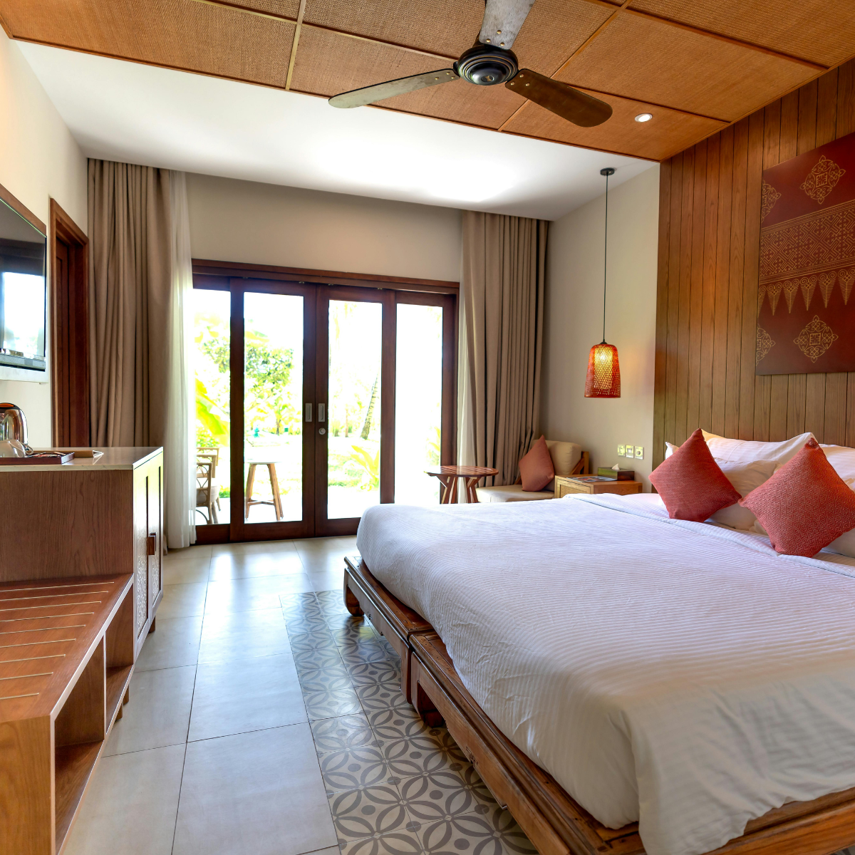 Standard Room with teak panelling, king bed and garden terrace doors